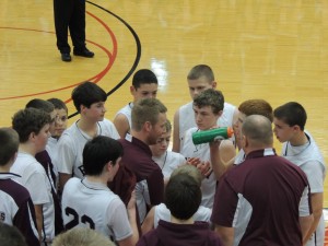 BMS coach John Cook (center) gives instruction to his team during a timeout in the Junior Rangers 61-49 victory in semi-final action in the Class L state tournament.  Benton will meet undefeated Marion in the championship game Thursday night at 7:30 p.m.
