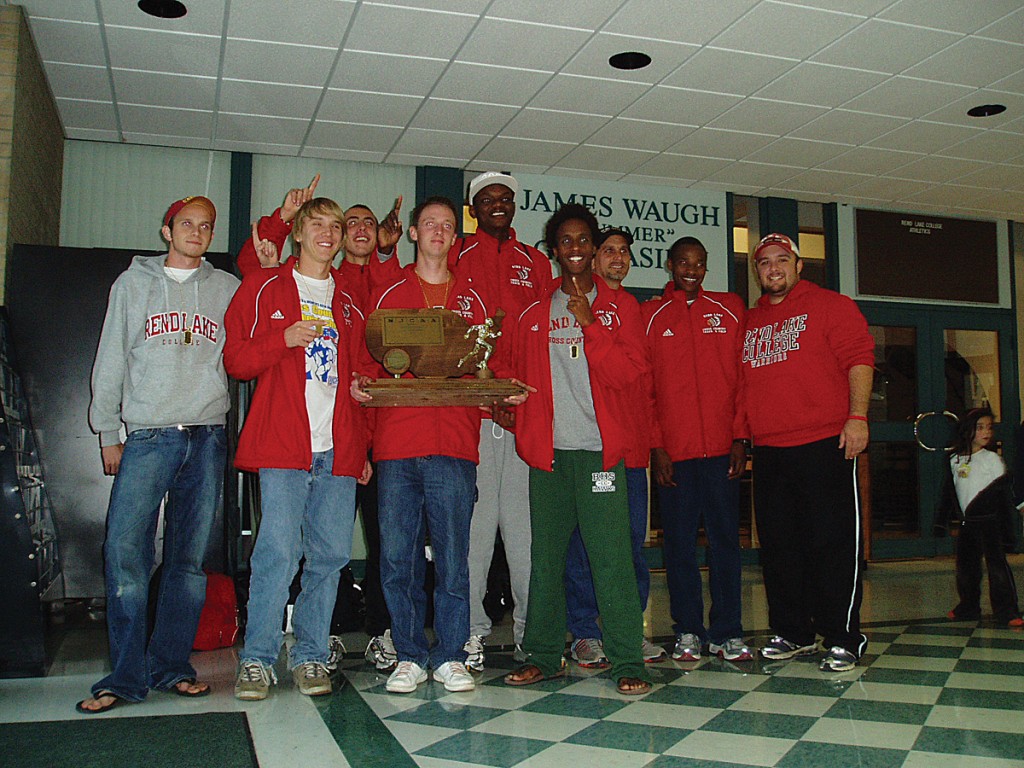 CHAMPS - The 2006 national championship cross country team is greeted upon their return from Texas to the Rend Lake College campus. L-R, Kyle Cash (Greenup, Ill.), Jeremy Whitaker (Granite City, Ill.), Trevor Popravak (Fort Myers, Fla.) , Cory Currie (Ontario, Can.), Steeve Gabart (Miami Shores, Fla.), Ahmed Mohamed (Carol Stream, Ill.), Head Coach Brent McLain, Elkanah Kibet (Eldoret, Ken.), Assistant Coach Mark McCall. (Photo by Nathan Wheeler/RLC Sports Information)