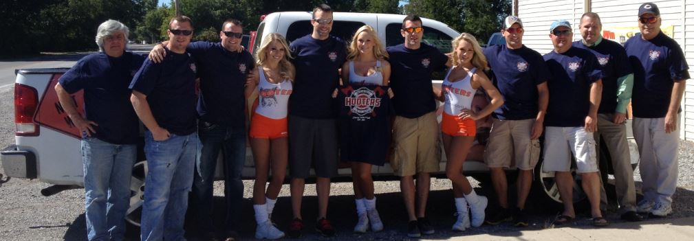 Benton firefighters are pictured with three Hooters' Girls, following a catered lunch on Tuesday.  The meal resulted from a controversy after the Benton city council refused to reimburse two firemen for meals at a Hooters restaurant while they were out of town receiving training. (Photo provided)