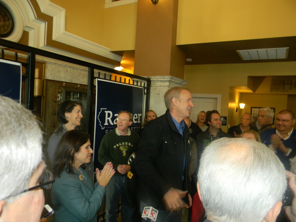 Newly elected governor Bruce Rauner, flanked by his wife Diana (in back) and Lt. Governor-elect Evelyn Sanguinetti were greeted by a large crowd at the Vault Cafe in Marion on Friday morning.