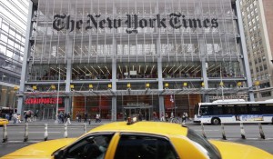 In this Oct. 18, 2011, file photo, traffic passes the New York Times building, in New York. The New York Times pushed back against President-elect Donald Trump, saying Thursday, Nov. 17, 2016, that its paid subscriptions have jumped since the election, despite what Trump has said on Twitter. (AP Photo/Mark Lennihan, File)