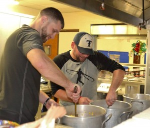 Coach Morgan and his assistant coach Scotty Clark in "pregame preparations" before the meal Saturday. 