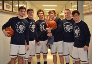 The Zeigler-Royalton senior basketball players with Coach Morgan's son, Grayson 